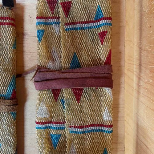 Beige blue and red clutch bag with leather wrap tie